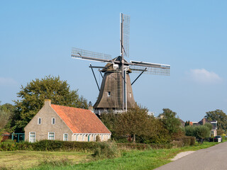 Fototapeta na wymiar Windmill Swaechmermolen or Langweerder molen in Langwar, Friesland, Netherlands