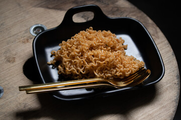 Korean instant noodles in a black plate