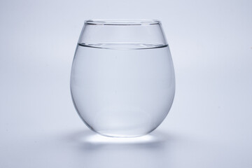 Clear glass filled with water on a white background