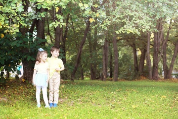 Fototapeta premium Family with children for a walk in the summer park. Сoming autumn&nbsp;in the park. Family. Fall. Happiness.