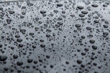 Wet metal surface after rain. Hydrophobic effect and water drops on car varnish after using ceramic coating