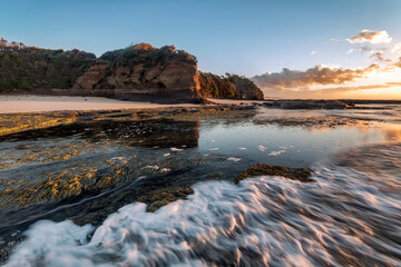 a body of water with a mountain in the background