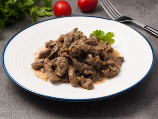liver stewed in sour cream with onions. close-up
