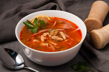 traditional Russian soup solyanka in a white bowl