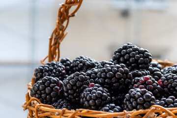 Ripe fragrant blackberries in wicker basket. Fragment, close-up. Rubus fruticosus . Topic:...