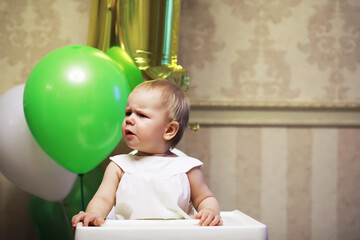 Fototapeta na wymiar Birthday one year old girl with baloons