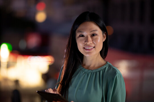 Portrait of businesswoman woman working at night using tablet