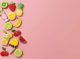 Tropical summer theme colorful sugar icing cookies on light pink background, tropical fruit cookie shapes