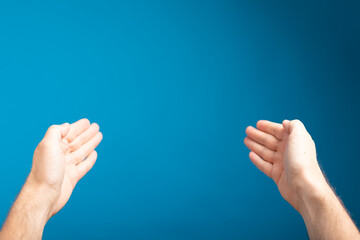 male  shows outstretched hand with open palm