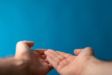 male  shows outstretched hand with open palm
