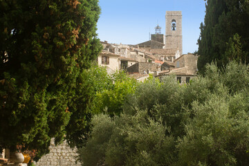 Fototapeta na wymiar The village of Saint Paul de Vence framed by century-old cypress trees on a summer day on the French Riviera