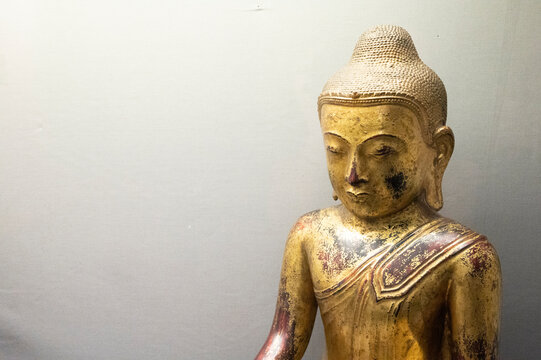 Hartlepool, U.K - July 27, 2021: The National Museum of The Royal Navy, in the North of England. Wooden golden Budha statue.