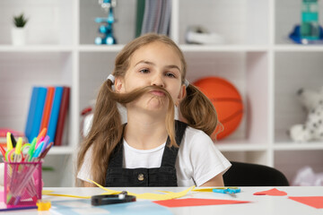 funny child having fun with long hair pony tail at school lesson in classroom wear uniform, fun