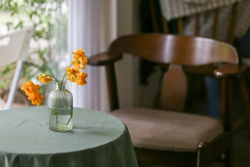 selective focus glass vase with yellow flowers. shop decoration concept Use materials near the body of the leftovers, old bottles. There is space for text.