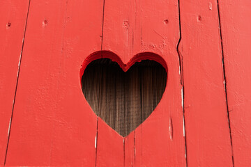 Heart shape sawn into the red painted wood