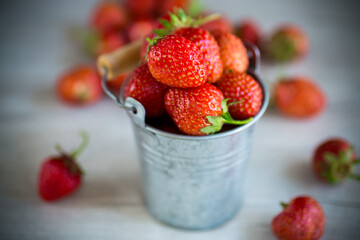 red ripe natural strawberries on a wooden table