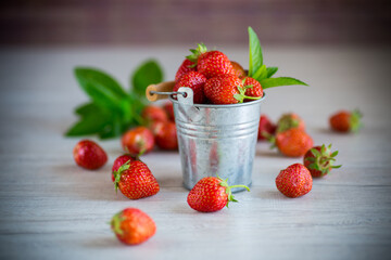 red ripe natural strawberries on a wooden table