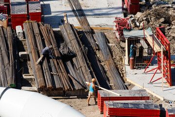 workers make metal reinforcement for the foundation