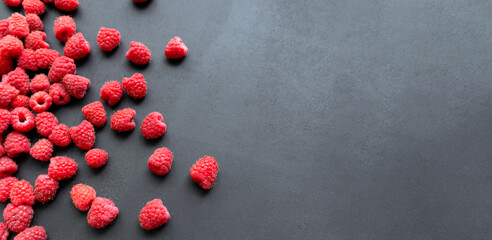 Fresh and sweet raspberry in a dark background. Top view