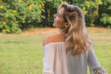 Beautiful happy woman laughing and enjpying in the park