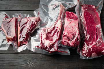 Raw marbled beef steak in vacuum packaging, tomahawk, t bone, club steak, rib eye and tenderloin...