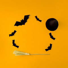 Creative look made of bats, hats and a witch's broom. Minimum flat laying. Halloween concept. On a...