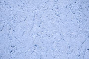 soft focus background view of plaster strokes on wall textured surface blue toning color empty copy space for your text
