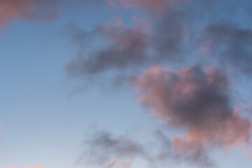 Clouds sunset background. Pastel delicate shades of the sky. Beautiful clouds for an airy light summer design. The concept of lightness, weightlessness, romance, tenderness. Sky with purple clouds