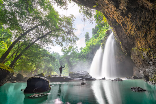 Tourist trekking to see the amazing of Haew Suwat Waterfall. Unseen Khao Yai National Park, Thailand. Tourists trekking see waterfall in tropical rainforest. Hiking nature trail, traveling ecotourism.