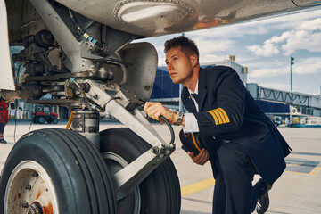 Licensed pilot examining the landing gear system © Viacheslav Yakobchuk