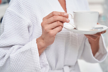Woman drinking tea during visit to beauy salon