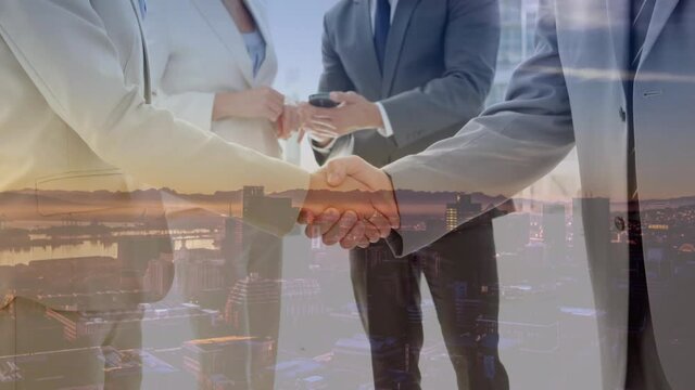 Digital composition of caucasian businessman and businesswoman shaking hands against cityscape