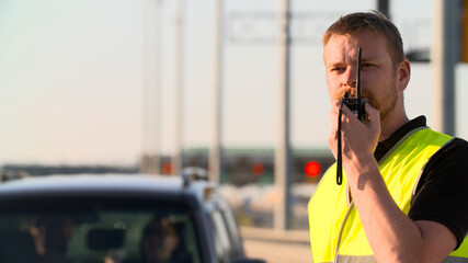 Traffic policeman using walkie talkie working at highway