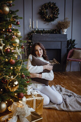 Beauty woman near Christmas tree with presents. New Year Concept.