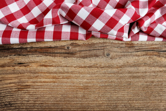 Checkered Red And White Table Cloth On Wooden Background, Copy Space.