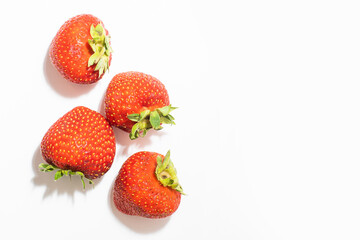 Ripe red strawberries on a white background