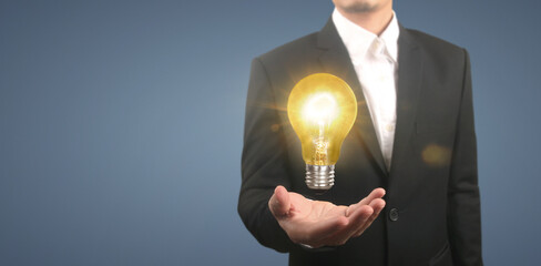 Hand of holding illuminated light bulb,  innovation inspiration concept