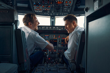 Two aviators sitting in the cockpit of an aircraft © Viacheslav Yakobchuk