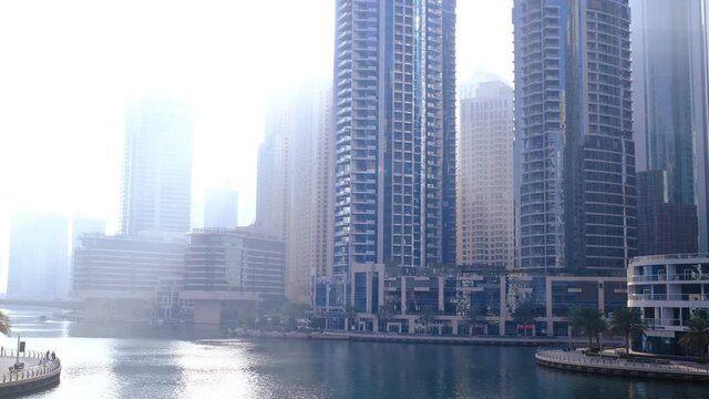 Dubai, UAE, 15.02.2021: Dubai Marina skyline with Marina Canal, modern skyscrapers, luxury hotels and the sunlight floods the bay at daybreak