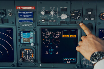 Professional Caucasian airline captain navigating an airplane