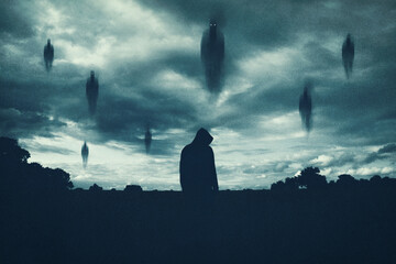 A supernatural concept. Of spirits floating above a hooded figure in the countryside at night. With a grunge, textured edit.