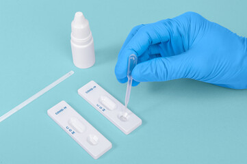 scientist or doctor hand using Rapid antigen test cassette quick fast testing identifying antibodies for COVID-19 Coronavirus Dropping sample in antigen taplet