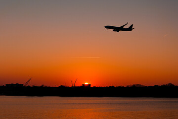 Fototapeta na wymiar Jet at sunset over the Tidal Basin, Washington, DC