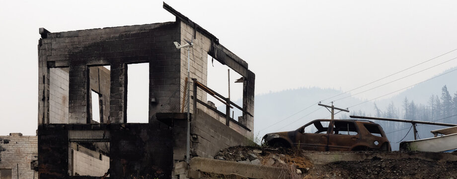 Fire Debris of Houses in a small town with smoke in sky. Caused by Forest Wildfires in Lytton, British Columbia, Canada.