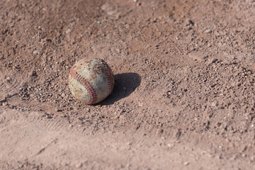 Fototapeta na wymiar baseball on red clay sand (pitcher's mound)