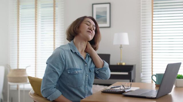 Asia people busy bored lady sitting bad posture work online videocall meeting at desk home tired in life suffer from chronic pain, burnout brownout mental health care relief, hard workload job relax.