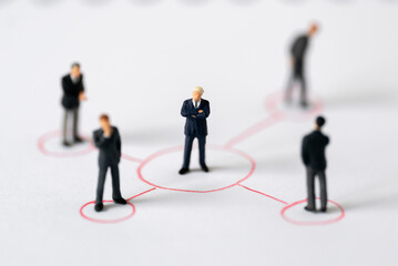 Miniature people Group of Businessman mini figures standing thinking on Graphic Info white background using as Success Business partnership development and Commerce Strategy winning Planning concepts