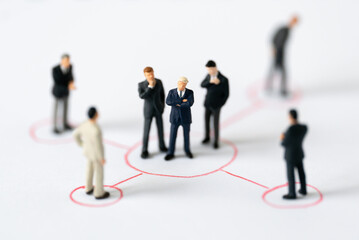 Miniature people Group of Businessman mini figures standing thinking on Graphic Info white background using as Success Business partnership development and Commerce Strategy winning Planning concepts