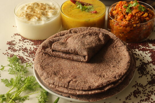 Indian flatbread made of finger millet flour. Served with a fire roasted brinjal dish, Lentil curry and spiced curd