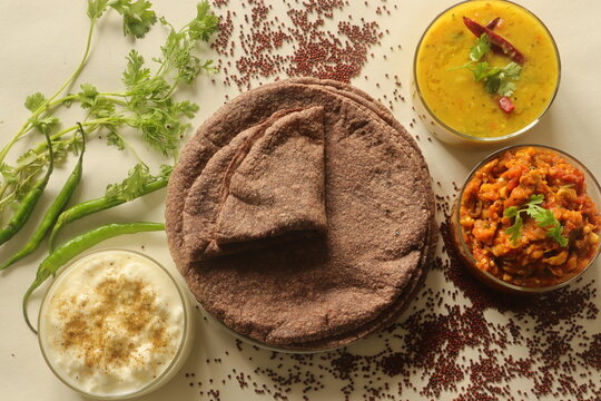 Indian flatbread made of finger millet flour. Served with a fire roasted brinjal dish, Lentil curry and spiced curd